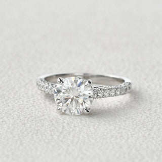 round-cut-solitaire-pave-moissanite-engagement-ring