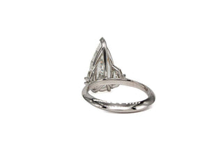 three stone moissanite engagement ring pear close sparkle