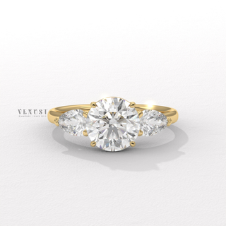 round diamond pear side ring
round diamond engagement ring
pear side stone engagement ring
round center pear side stones
three stone diamond ring