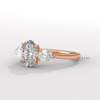 oval three stone engagement ring
oval diamond three stone ring with pear side stones
oval cut engagement ring with pear side diamonds
oval center pear side stone engagement ring
